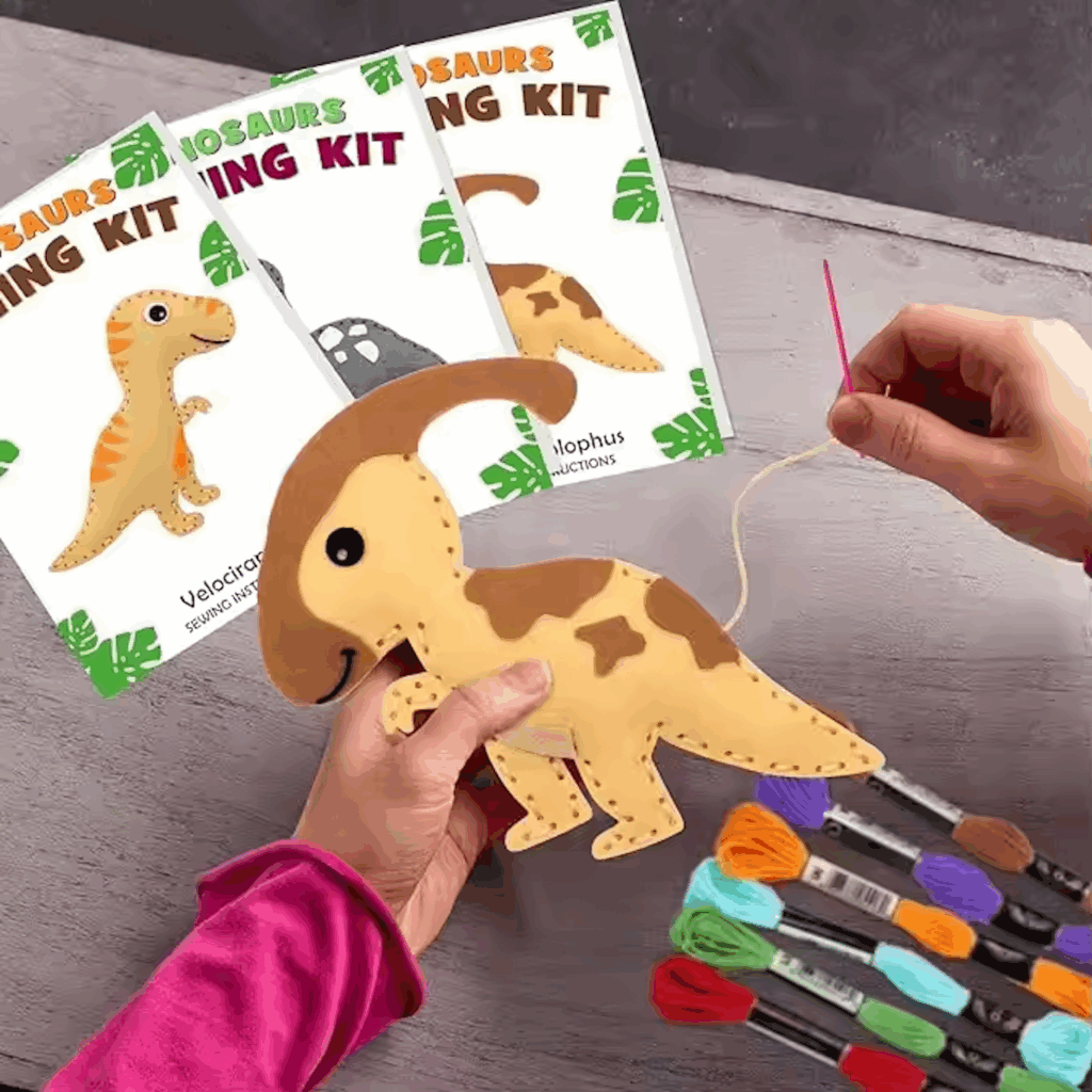 DIY felt dinosaur sewing kit for kids with pre-cut pieces, threads, and accessories